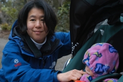 Christine strapping Katherine into the stroller